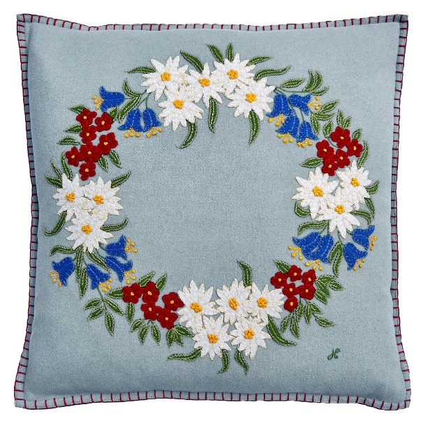 A blue pillow with a floral design

Description automatically generated