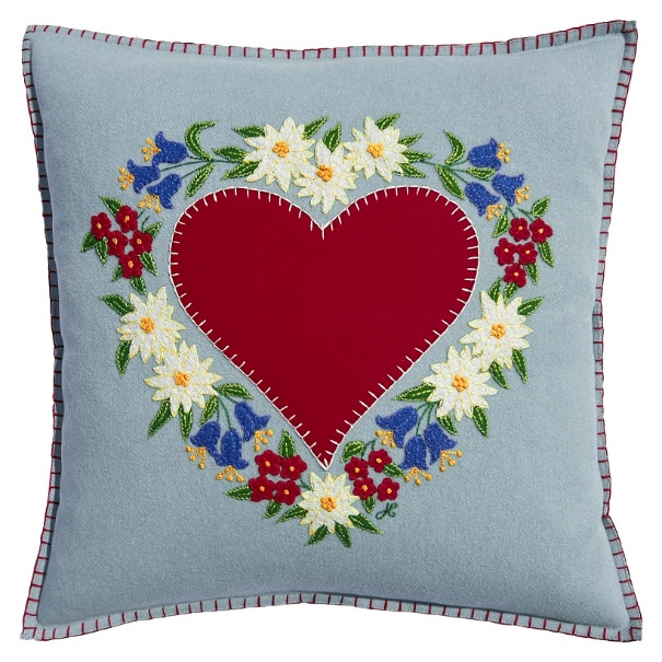 A heart shaped pillow with flowers

Description automatically generated
